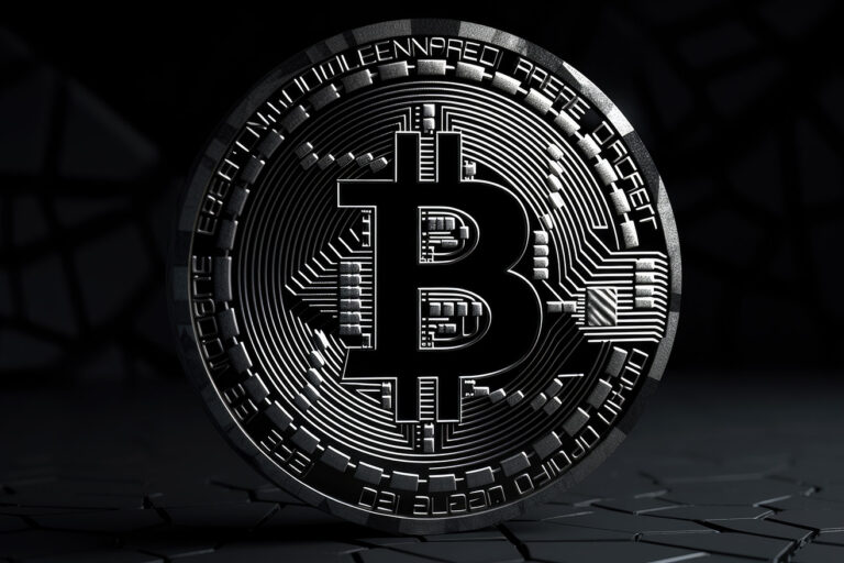 Black bitcoin logo standing on black surface